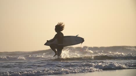 Surfer-Running-Along-a-Beach