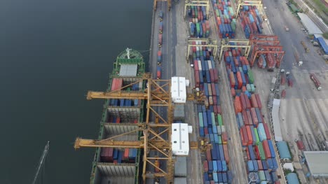 Small-Boat-Sailing-Past-Container-Port