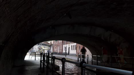 Tracking-Shot-of-People-Going-Through-a-Canalside-Tunnel-