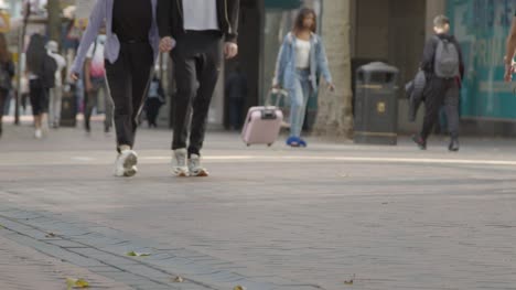 Defocused-Shot-of-Feet-Walking-Through-Busy-Street-In-Birmingham